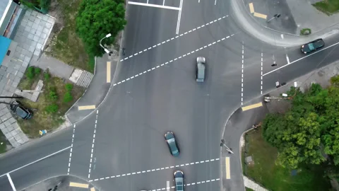Overhead drone shot of traffic driving over roundabout with highway tunnel Stock Footage 138497193