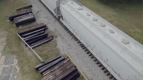 Overhead drone shot while train moves. Booms down and tilts up. Stock Footage 82448148