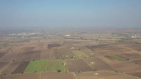Overhead drone sweep across a patchwork of agricultural lands featuring rich Video stock 337127753