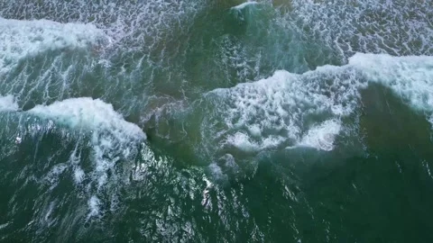 An overhead drone video of waves crashing along the shore in palm beach county Stock Footage 328293876