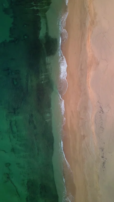 Overhead drone view of calm waves lapping on sandy beach Stock Footage 293064147
