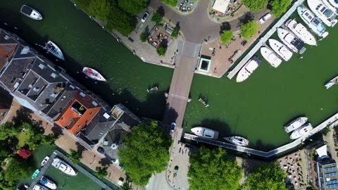 An overhead drone view of a charming canal with boats docked along the edges Stock-Footage 313806557