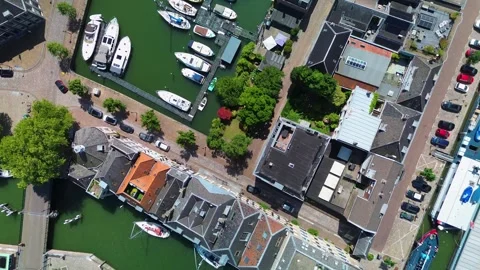 An overhead drone view of a charming canal with boats docked along the edges Stock-Footage 314040745