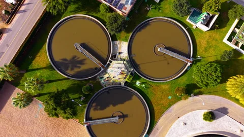 Overhead drone view of circular sedimentation tank at water treatment facility, Stock Footage 337463535