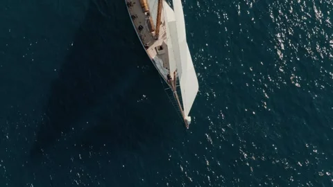 Overhead drone view of a classic sailing yacht racing under full white sails Stock Footage 345292996