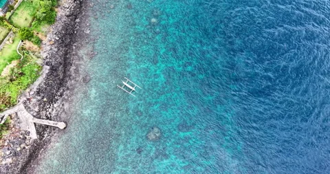 Overhead Drone View of Coral Reef Coastline and Jukung Boat in Amed Bali Stock Footage 334372055