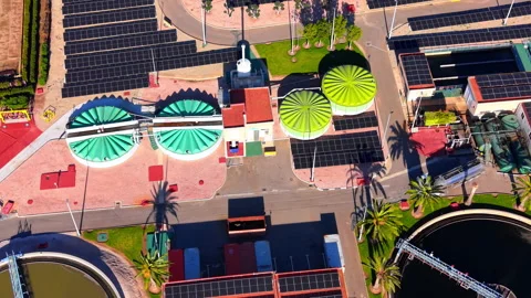 Overhead drone view of covered digester and solar panel array at treatment Stock Footage 337464760