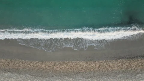 Overhead drone view of gentle surf on the beach Stock Footage 264431912