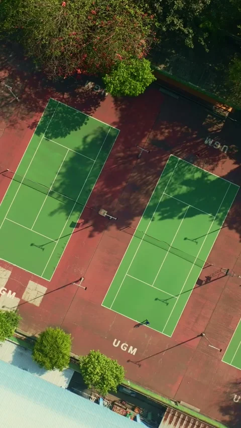 Overhead drone view of green and red tennis courts Stock Footage 342589742