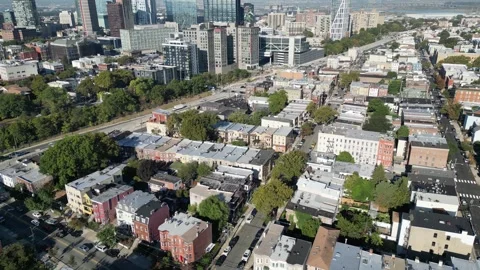 Overhead drone view of Jersey City rooftops, intersecting roads, long shadows Stock Footage 321882713