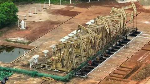 Overhead drone view of oil pumpjacks in a structured row. Stock Footage 331280278