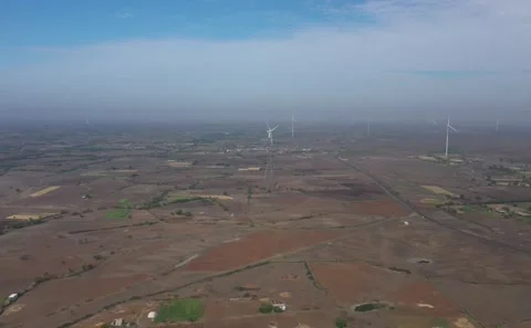 Overhead Drone View of Rural Wind Energy Turbine Set Against Patchwork Farming Vídeo Stock 342489122