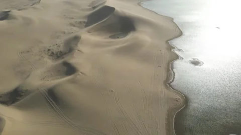 Overhead Drone View of Sand Dunes and Lake Ejina Inner Mongolia China Stock Footage 330454895
