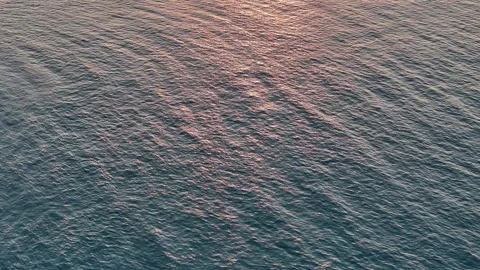 Overhead drone view of the sea at sunset Stock Footage 264191877