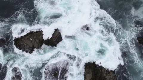 Overhead drone view waves hitting rocks - Sonoma Coast, California 4K Stock Footage 146142714