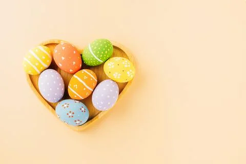 Overhead easter eggs in shape heart isolated on pastel background Stock Photos