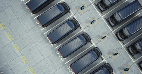 Overhead Electric EV delivery vans are being charged in company parking garage Stock Footage 238760407