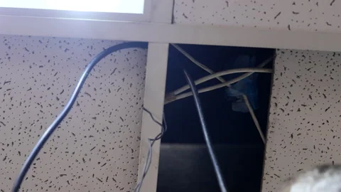 Overhead Electrical Work with Sectional Ceiling Tiles Stock Footage 292371356
