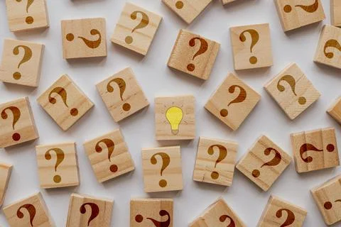Overhead flat lay view of a single yellow light bulb idea icon on a wooden .. Stock Photos