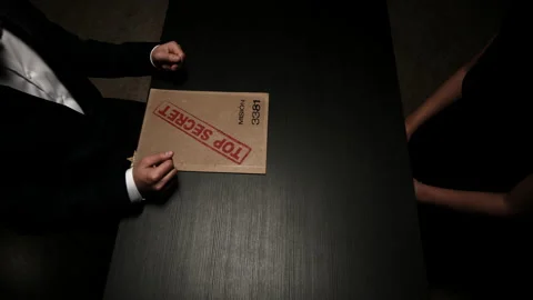 Overhead folder of secret mission file being handed over to agent Stock Footage 160015788