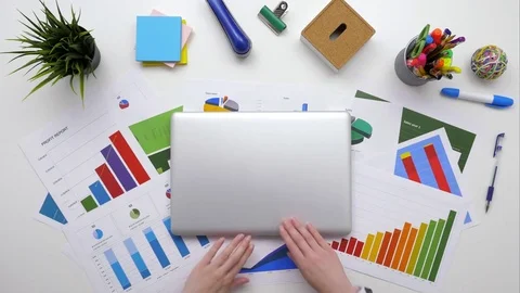 Overhead footage of female analyst checking data on laptop Stock Footage 79648362