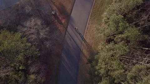 Overhead footage of two runners running down a mountain road 動画素材 113530296
