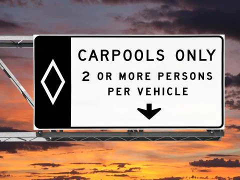 Overhead freeway carpool only sign with sunset sky Stock Photos