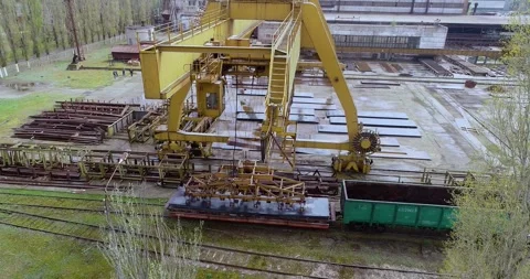 Overhead gantry crane loading steel sheets with magnet. Gantry crane lifting Stock Footage 319938658