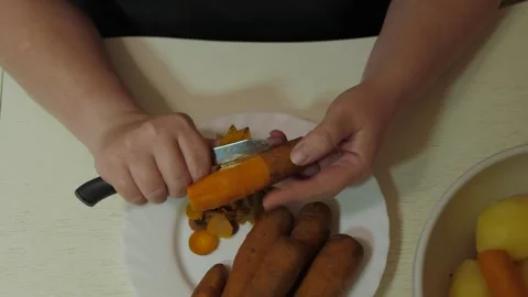 Overhead hands peeling boiled carrot Stock-Footage 342362183