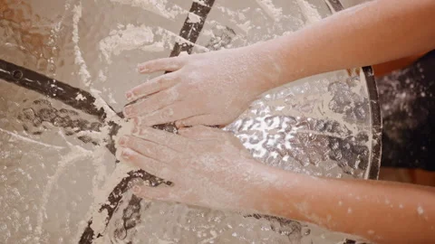 Overhead hands scattering flour across glass table while preparing pumpkin pie Stock Footage 346410950