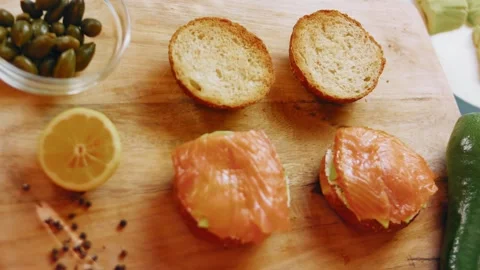 Overhead ingredient layout with salmon, lemon and bagels, 4K Stock Footage 341120622