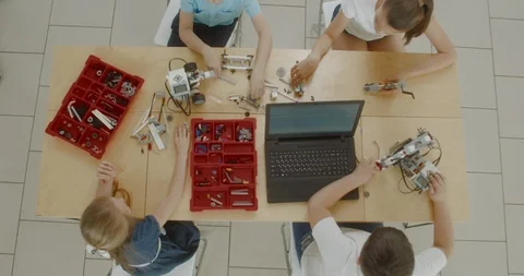OVERHEAD kids working on a functional programable robot during robotics class Stock Footage 108892608