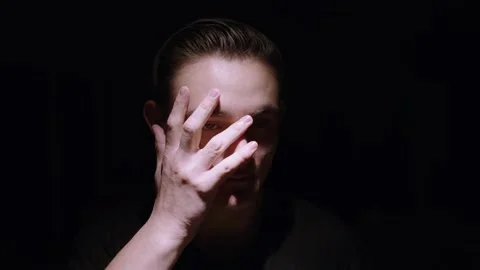 Overhead lit caucasian model poses in dark room Stock Footage 143069009