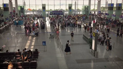 Overhead lobby shot of people checking in at the Noi Bai Airport terminal Stock Footage 56365294