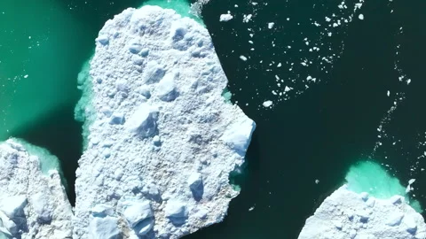 Overhead Look at Chunks of Icebergs in Green Water Stock Footage 292940550