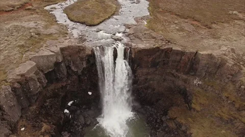 Overhead look at a river dropping off a basalt lip Видео 64878265