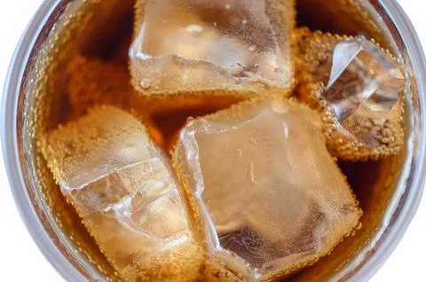 Overhead macro shot of carbonated soft drink with melting ice cubes Stock Photos