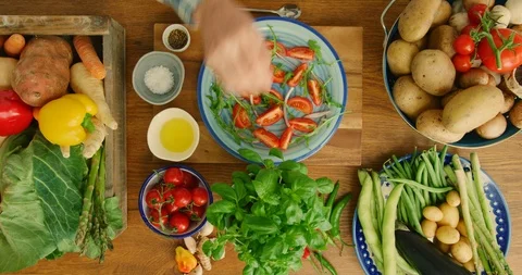 Overhead Of Man Adding Basil Leaves To A Tomato Salad 4K Stock Footage 92377710