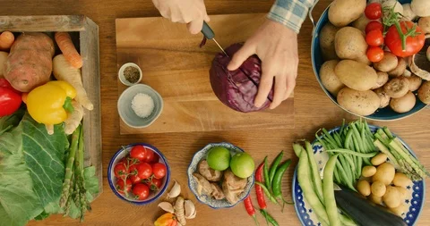 Overhead Of Man Cutting Red Cabbage With Knife On Wooden Board In Kitchen 4K Stock Footage 92378091