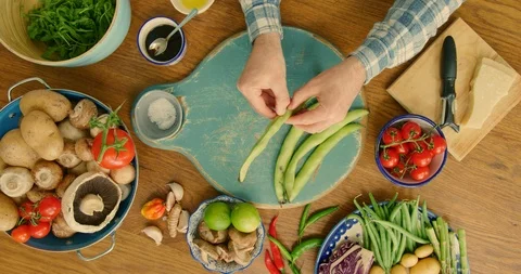 Overhead Of Man Shelling Broad Beans In Kitchen 4K Stock Footage 92481944