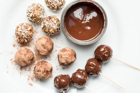 Overhead of Melted Chocolate Surrounded by Various Protein Energy Balls Stock Photos