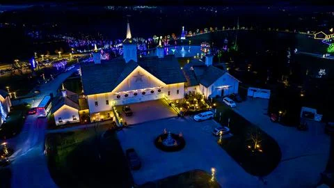 Overhead Night View Of A Complex With Buildings Outlined In Lights, A Central Stock Photos