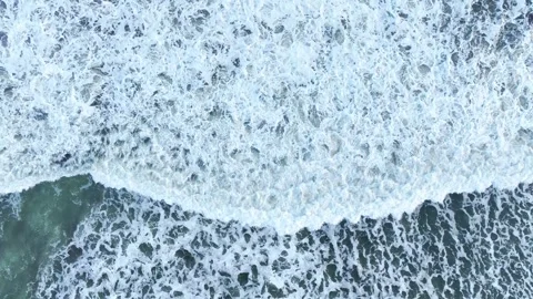 Overhead ocean foam pattern on moving waves Stock Footage 335440353
