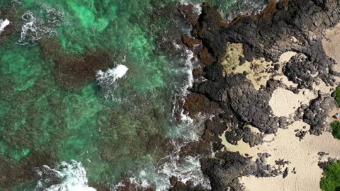 Overhead of ocean waves breaking on lava rocks at shoreline 4k Stock Footage 155779192
