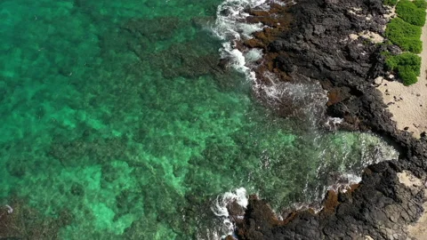 Overhead of ocean waves breaking on lava rocks at shoreline 02 4k Stock Footage 155779386