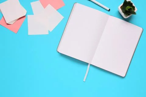 Overhead of office table with notepad, notebook and clock and felt pen. Copy  Stock Photos
