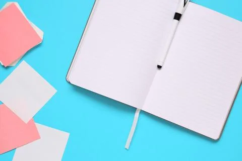 Overhead of office table with notepad, notebook and clock and felt pen. Copy  Stock Photos