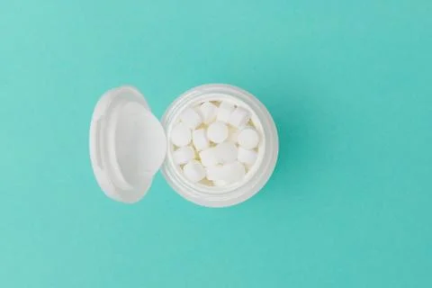 Overhead of Opened Bottle Filled with White Pills Stock Photos