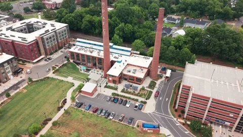 Overhead orbit of repurposed industrial buildings in South Carolina Stock Footage 338009128