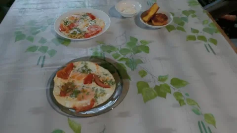 Overhead pan across breakfast table with omelettes, bread, beverages Stock Footage 347219150